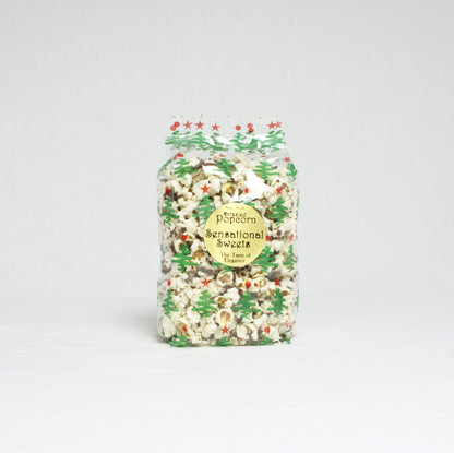 Packaged popcorn with festive design on a light gray background